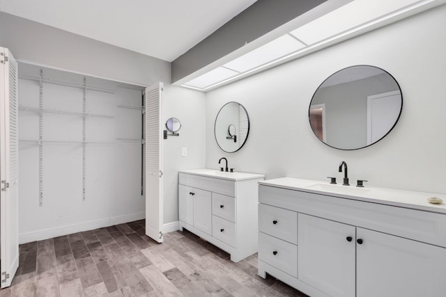 3665 Silver Lace Ln Unit 80, Boynton Beach, FL 33436 - bathroom featuring two vanities and wood finished floors