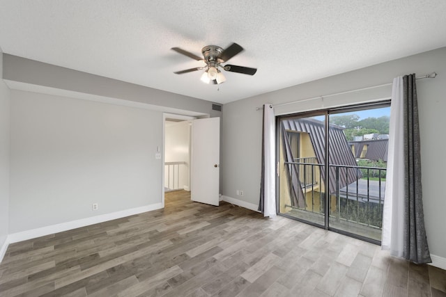 3665 Silver Lace Ln Unit 80, Boynton Beach, FL 33436 - empty room with ceiling fan, wood finished floors, and a textured ceiling