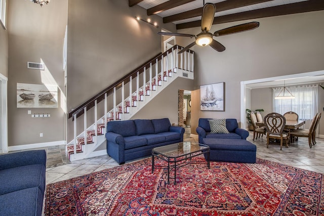 130 S Ocean Breeze, Lake Worth Beach, FL 33460 - living area with high vaulted ceiling, stairway, ceiling fan, tile patterned flooring, and a wooden ceiling with exposed beams