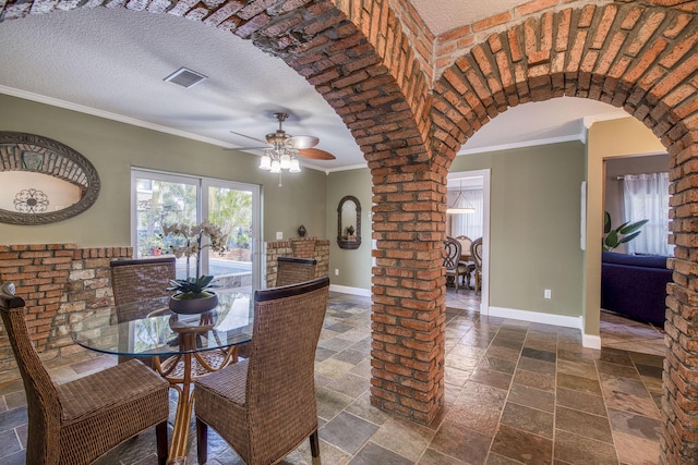 130 S Ocean Breeze, Lake Worth Beach, FL 33460 - dining space with stone tile flooring, arched walkways, crown molding, and a ceiling fan