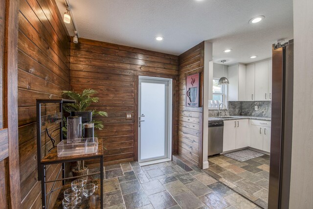 130 S Ocean Breeze, Lake Worth Beach, FL 33460 - kitchen with stainless steel appliances, white cabinetry, a textured ceiling, backsplash, and recessed lighting