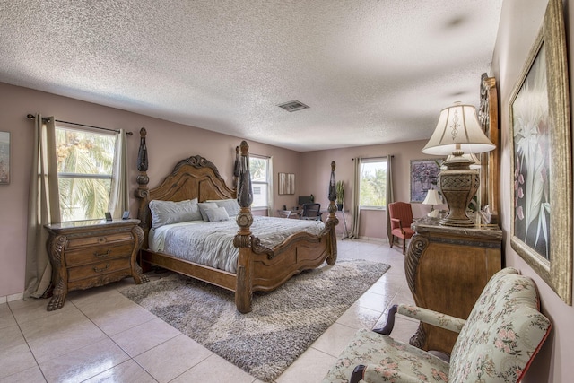 130 S Ocean Breeze, Lake Worth Beach, FL 33460 - bedroom with light tile patterned floors and a textured ceiling