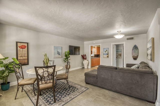 130 S Ocean Breeze, Lake Worth Beach, FL 33460 - living area featuring light tile patterned floors and a textured ceiling