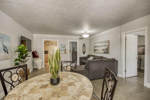 130 S Ocean Breeze, Lake Worth Beach, FL 33460 - dining space featuring baseboards and a textured ceiling