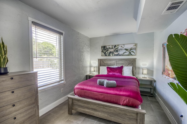 130 S Ocean Breeze, Lake Worth Beach, FL 33460 - bedroom featuring a textured wall and tile patterned floors