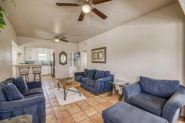 130 S Ocean Breeze, Lake Worth Beach, FL 33460 - living area featuring ceiling fan, light tile patterned floors, and a textured wall