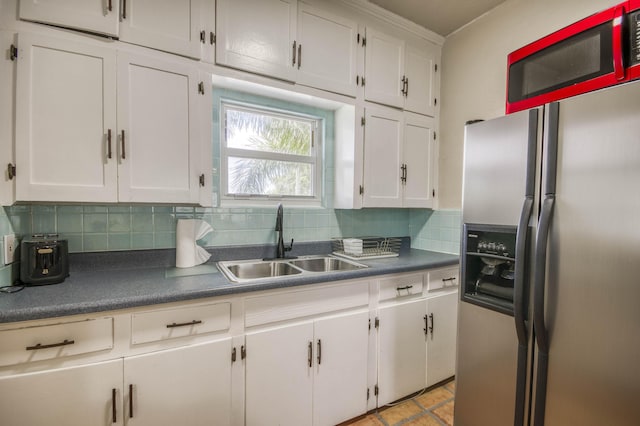 130 S Ocean Breeze, Lake Worth Beach, FL 33460 - kitchen with stainless steel refrigerator with ice dispenser, decorative backsplash, white cabinets, and dark countertops