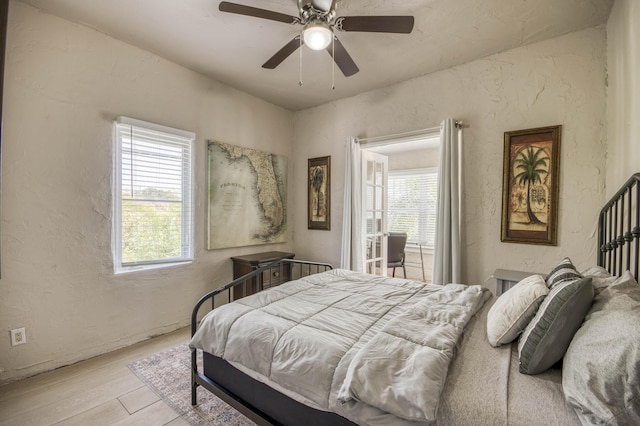 130 S Ocean Breeze, Lake Worth Beach, FL 33460 - bedroom featuring a textured wall, multiple windows, wood finished floors, and ceiling fan
