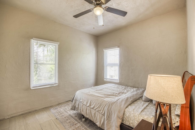 130 S Ocean Breeze, Lake Worth Beach, FL 33460 - bedroom with a textured wall, wood-type flooring, and ceiling fan