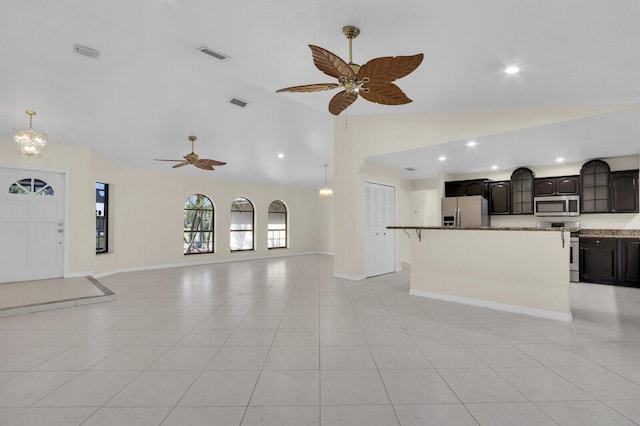 2774 SE Howell Ave, Port Saint Lucie, FL 34952 - unfurnished living room featuring lofted ceiling, a ceiling fan, recessed lighting, light tile patterned floors, and a chandelier