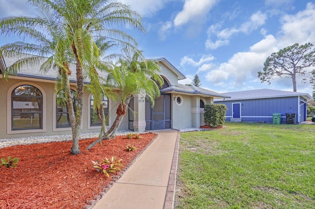 2774 SE Howell Ave, Port Saint Lucie, FL 34952 - view of front of property featuring a front yard and stucco siding