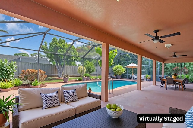 2774 SE Howell Ave, Port Saint Lucie, FL 34952 - fenced backyard featuring an outdoor living space, a patio area, a ceiling fan, outdoor dining space, and glass enclosure