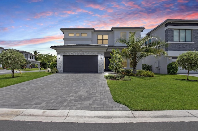 8516 Swinley Forest Way, Boca Raton, FL 33434 - contemporary house featuring decorative driveway, stucco siding, a front yard, and an attached garage