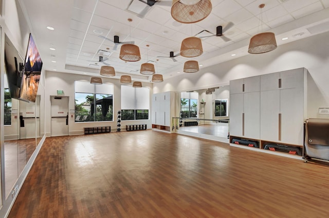 8516 Swinley Forest Way, Boca Raton, FL 33434 - exercise area with a paneled ceiling, wood finished floors, a towering ceiling, ceiling fan, and radiator