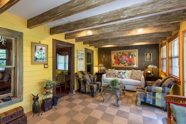 1016 N E St, Lake Worth Beach, FL 33460 - living room featuring wood walls, beam ceiling, and tile patterned floors