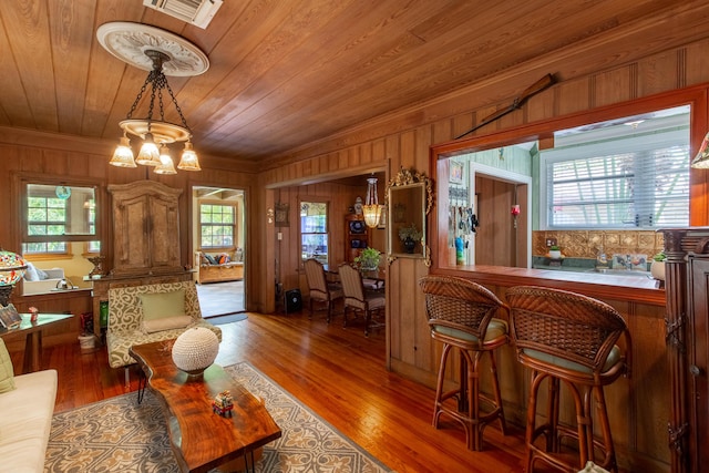1016 N E St, Lake Worth Beach, FL 33460 - living area with wooden ceiling, a chandelier, wood walls, and wood finished floors