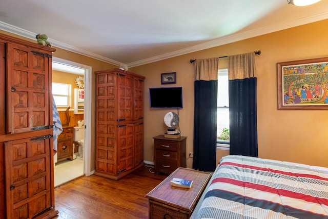 1016 N E St, Lake Worth Beach, FL 33460 - bedroom with wood finished floors, crown molding, and connected bathroom