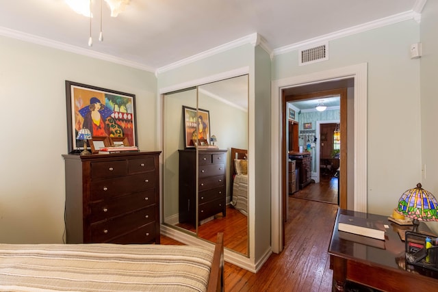 1016 N E St, Lake Worth Beach, FL 33460 - bedroom featuring hardwood / wood-style floors, ornamental molding, and a closet
