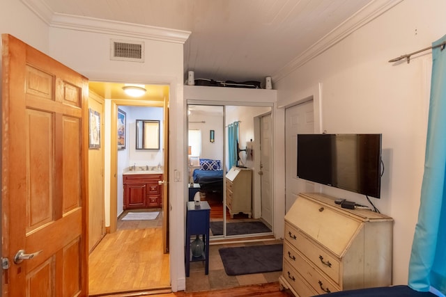 1016 N E St, Lake Worth Beach, FL 33460 - bedroom featuring crown molding and light wood-style flooring