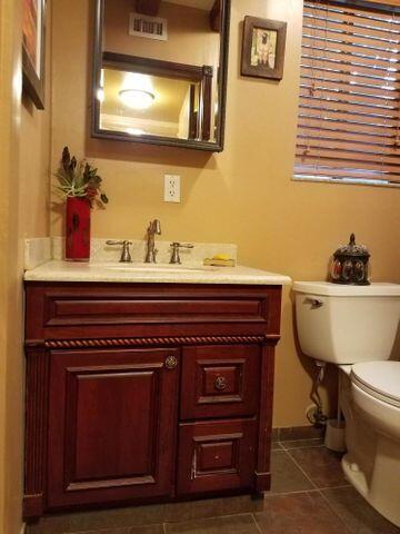 1016 N E St, Lake Worth Beach, FL 33460 - half bathroom with vanity and tile patterned flooring