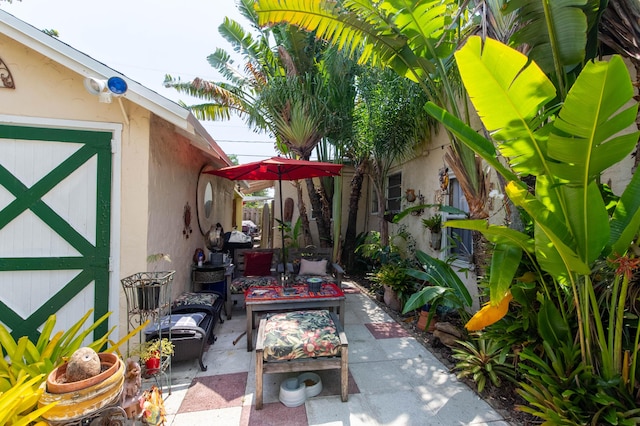 1016 N E St, Lake Worth Beach, FL 33460 - view of patio with an outdoor structure and an outdoor living space