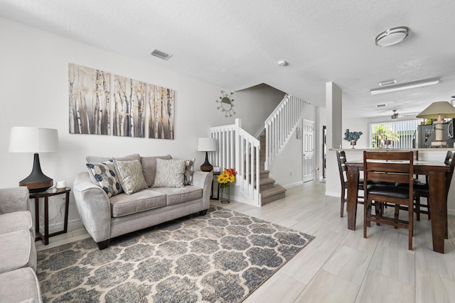1947 Gardenia Ct, Riviera Beach, FL 33404 - living area with a textured ceiling and stairs