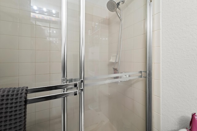1947 Gardenia Ct, Riviera Beach, FL 33404 - bathroom with a textured wall and a stall shower