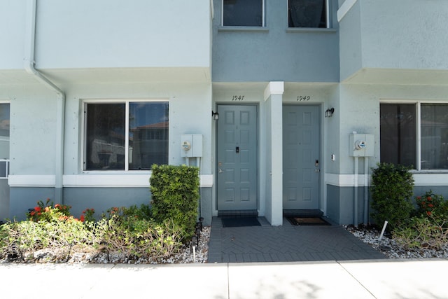 1947 Gardenia Ct, Riviera Beach, FL 33404 - doorway to property featuring stucco siding
