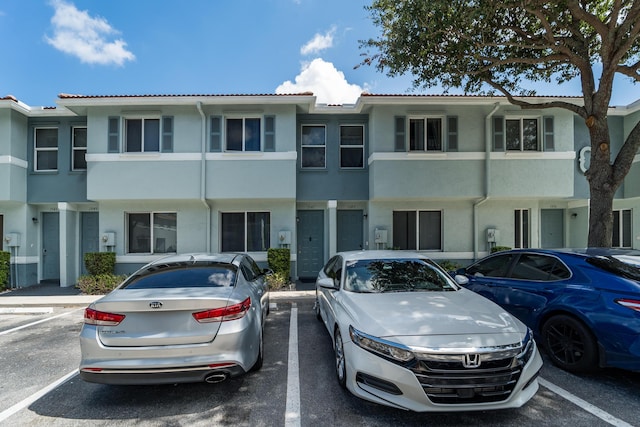 1947 Gardenia Ct, Riviera Beach, FL 33404 - view of property with uncovered parking, stucco siding, and a tile roof