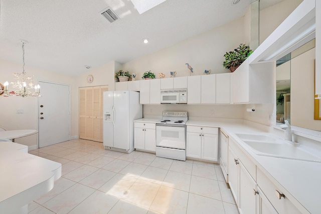 8368 Sunmeadow Ln, Boca Raton, FL 33496 - kitchen with white appliances, lofted ceiling, a chandelier, light countertops, and white cabinetry