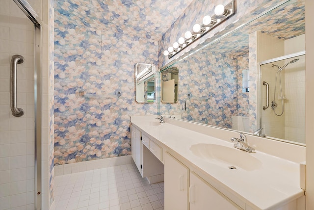 8368 Sunmeadow Ln, Boca Raton, FL 33496 - bathroom featuring wallpapered walls, tile patterned floors, double vanity, and tiled shower