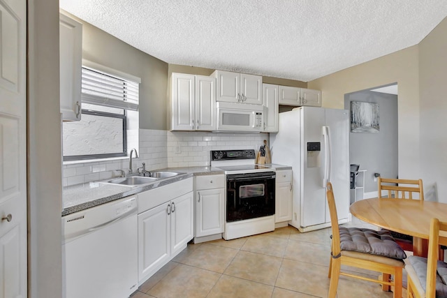 6855 W Broward Blvd Unit 406, Plantation, FL 33317 - kitchen with white appliances, backsplash, light countertops, a textured ceiling, and white cabinets