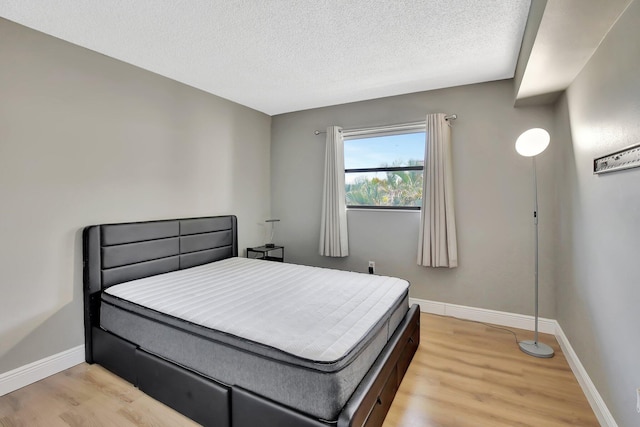 6855 W Broward Blvd Unit 406, Plantation, FL 33317 - bedroom with light wood-style flooring and a textured ceiling