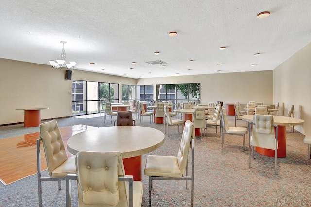 6855 W Broward Blvd Unit 406, Plantation, FL 33317 - carpeted dining area with a textured ceiling and a chandelier