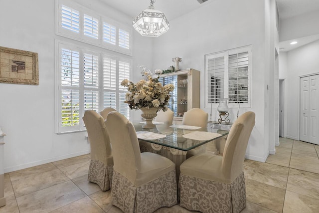 1267 SW Briarwood Dr, Saint Lucie West, FL 34986 - dining area with a high ceiling, a chandelier, and tile patterned floors