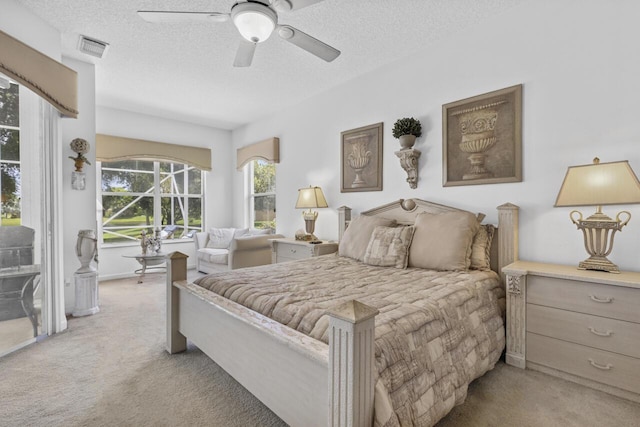 1267 SW Briarwood Dr, Saint Lucie West, FL 34986 - bedroom with light colored carpet, a textured ceiling, and a ceiling fan