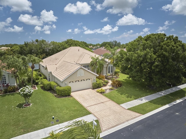 1267 SW Briarwood Dr, Saint Lucie West, FL 34986 - view of front facade featuring an attached garage, a front lawn, driveway, and stucco siding