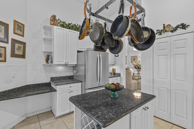 1267 SW Briarwood Dr, Saint Lucie West, FL 34986 - kitchen featuring freestanding refrigerator, open shelves, light tile patterned floors, and white cabinetry