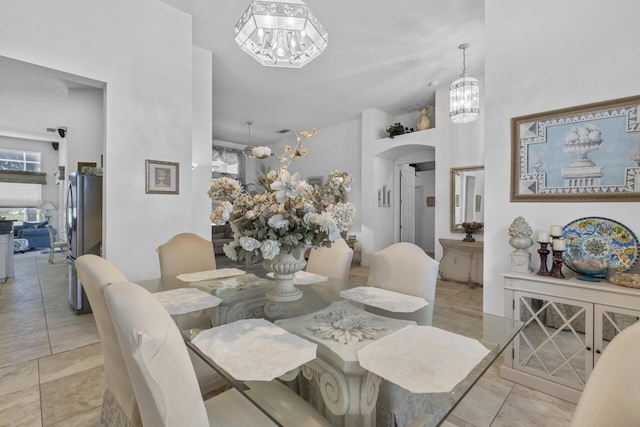 1267 SW Briarwood Dr, Saint Lucie West, FL 34986 - dining space with a chandelier, healthy amount of natural light, arched walkways, and light tile patterned floors