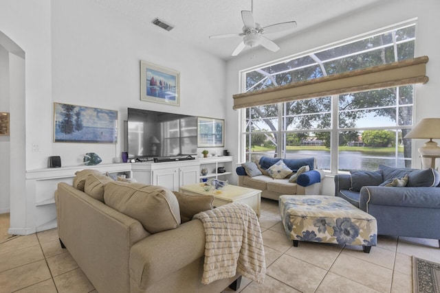 1267 SW Briarwood Dr, Saint Lucie West, FL 34986 - living room with light tile patterned flooring, a high ceiling, ceiling fan, and arched walkways