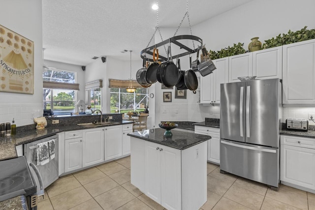 1267 SW Briarwood Dr, Saint Lucie West, FL 34986 - kitchen with stainless steel appliances, tasteful backsplash, white cabinetry, light tile patterned floors, and a textured ceiling