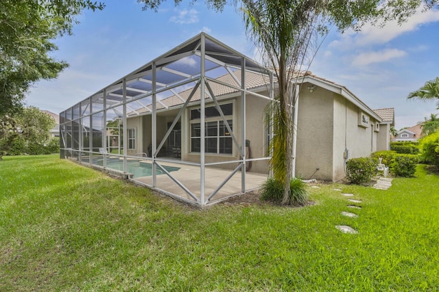 1267 SW Briarwood Dr, Saint Lucie West, FL 34986 - rear view of property with stucco siding, a patio area, an outdoor pool, and a yard