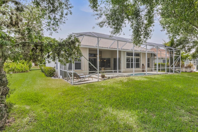 1267 SW Briarwood Dr, Saint Lucie West, FL 34986 - rear view of house featuring a patio area, a lawn, glass enclosure, and stucco siding