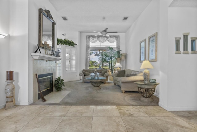 1267 SW Briarwood Dr, Saint Lucie West, FL 34986 - carpeted living room featuring a tiled fireplace and a ceiling fan
