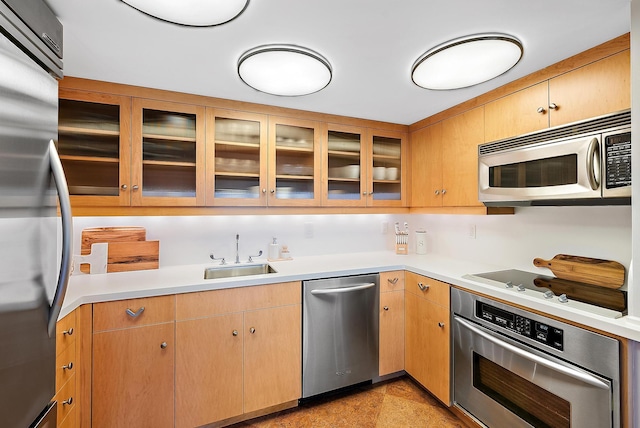 2 Church Ln Unit 115, North Palm Beach, FL 33408 - kitchen featuring appliances with stainless steel finishes, light countertops, and glass insert cabinets