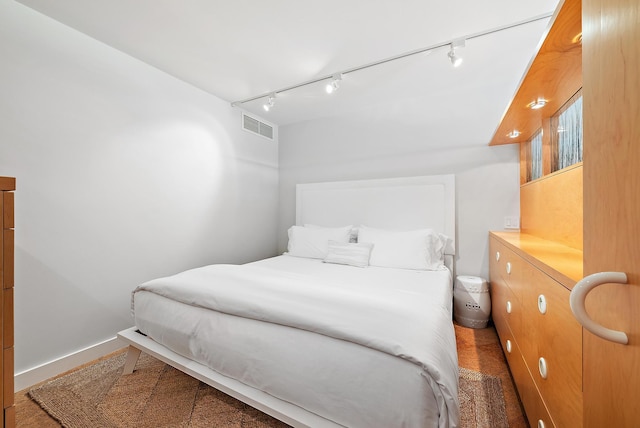 2 Church Ln Unit 115, North Palm Beach, FL 33408 - bedroom featuring track lighting and baseboards