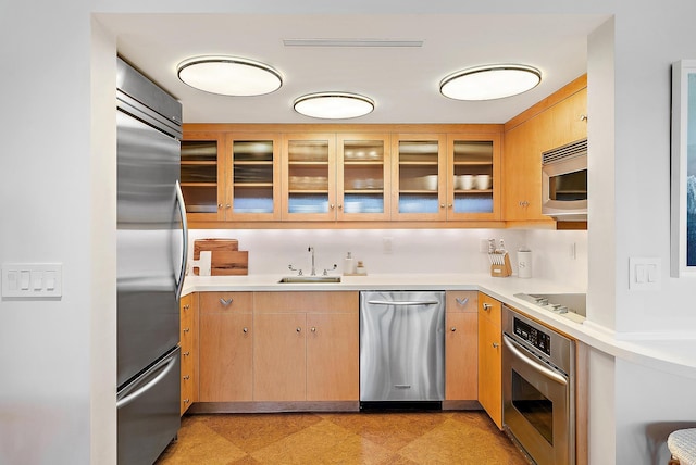 2 Church Ln Unit 115, North Palm Beach, FL 33408 - kitchen with appliances with stainless steel finishes, light countertops, and glass insert cabinets