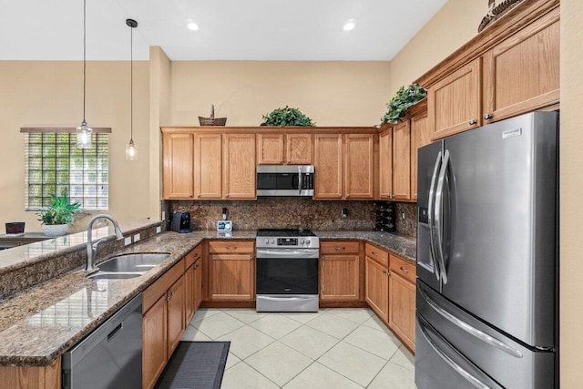 4086 Woodhill Pl, Boynton Beach, FL 33436 - kitchen featuring appliances with stainless steel finishes, a peninsula, tasteful backsplash, dark stone countertops, and light tile patterned floors
