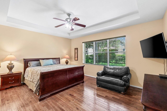 4086 Woodhill Pl, Boynton Beach, FL 33436 - bedroom with a tray ceiling, hardwood / wood-style flooring, and a ceiling fan