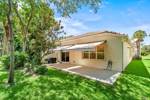 4086 Woodhill Pl, Boynton Beach, FL 33436 - back of house with a patio area, stucco siding, a yard, and a tiled roof